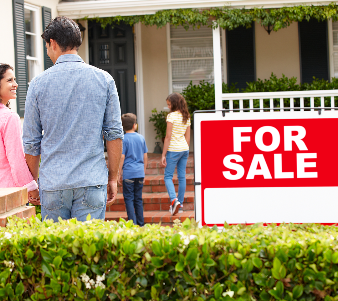 For sale signage in front of a house
